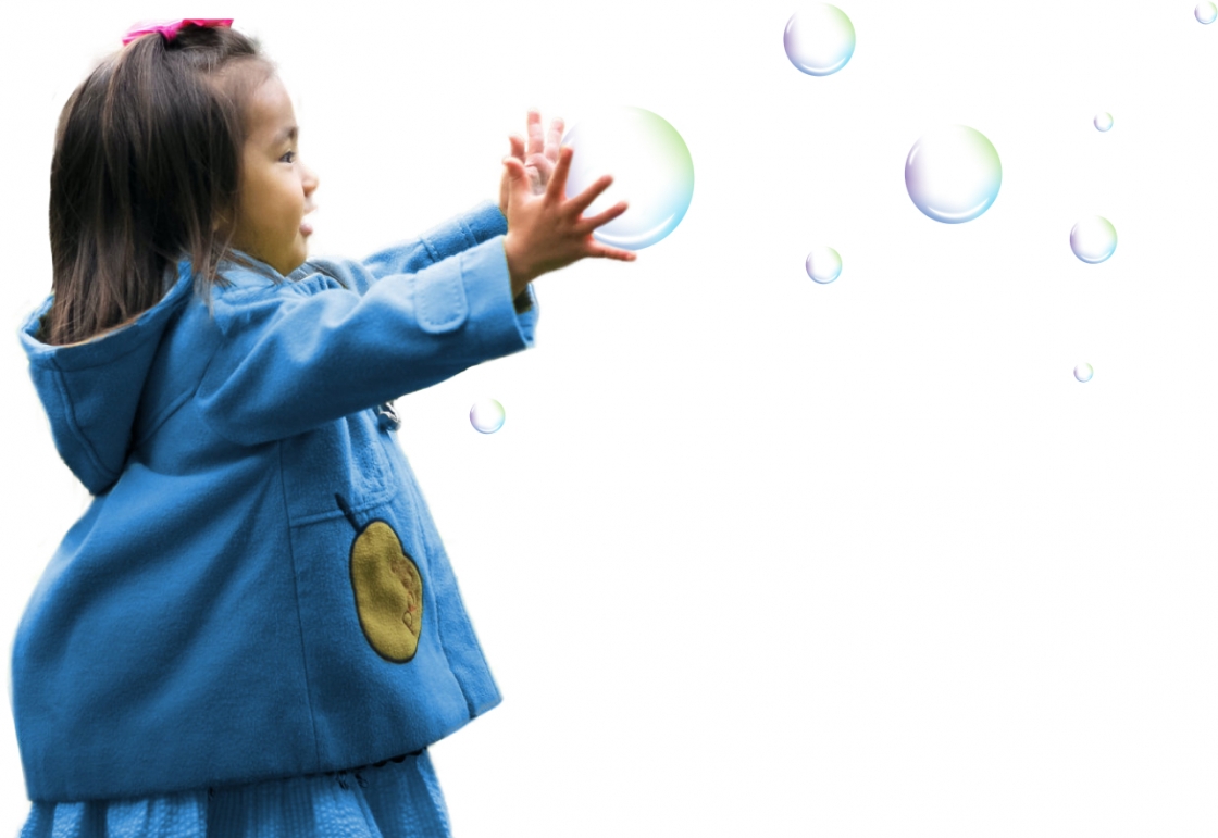 Little girl reaching out for bubbles